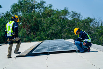 Wall Mural - two engineers install solar panels on a rooftop, wearing safety gear and helmets. the scene showcase