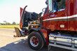 © Austockphoto - A red or maroon semi-trailer broken down with bonnet up.
