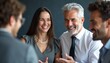 © natakot - A lively group of four professionals, including a smiling woman and two men, engage in a cheerful conversation. Their expressions radiate warmth and camaraderie, showcasing a vibrant atmosphere of