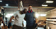 © BuyOutFelix01/peopleimages.com - Carpenter, team and men with smile, workshop and friends with glasses for safety, laughing and hug. Happy, artisan and people with eyewear in business, woodworking and contractor for furniture