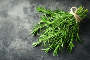 Poster - Freshly picked rosemary bundle on dark textured surface ready for culinary use and flavor enhancement
