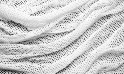 Poster - Delicate white net fabric with diamond patterns, draped in soft folds forming an abstract background.