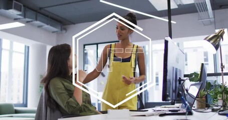 Poster - Two women discussing in office with NFT text animation overlay