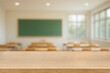 © ATRPhoto - Empty wood table top blurred background Cclassroom interior with wooden desk, green chalkboard. Back to School,  Academic Education Concept, Learning Space. For display or montage your products