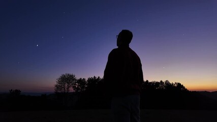 Wall Mural - silhouette of a man and countryside under the stars and moonlight.