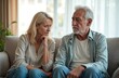 © miss irine - Upset senior couple sits sofa. Elderly man woman feel sad after argument. Relationships problems, divorce, family troubles concept. Negative emotions, mental health issues in mature age.