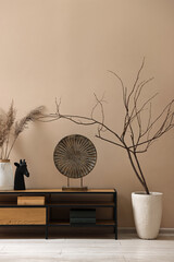 Poster - console table and decor near dark beige wall in room. interior design