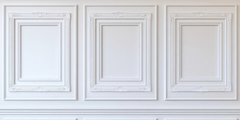 Fragment of an interior made of classic whhite panels. Elegant white wall with decorative moldings and empty picture frames.
