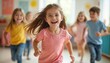 © miss irine - Happy little girl running towards camera with friends in preschool, classroom, kindergarten. Smiling kids playing and having fun, positive emotion, childhood joy, happiness. Together, teamwork.