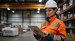 © all is well - Woman in safety gear using tablet in warehouse with shelves and boxes in the background area space