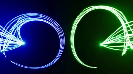 Poster - Green and blue light trails dance across a dark background, forming arrows and abstract shapes, creating a visually captivating display of movement and energy