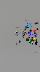 Poster - Multicolored ceramic tiles bursting, spinning dynamically across neutral gray surface, generating kinetic abstract animation with vibrant, chaotic energy and fluid fragmentation