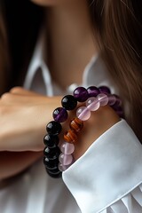 Poster - Elegant close up of gemstone bracelets featuring amethyst, tiger eye and quartz on a woman's wrist : Generative AI