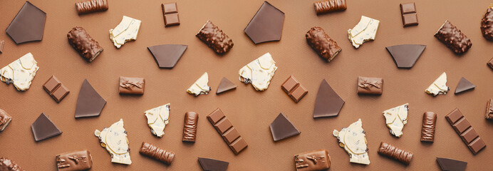 Wall Mural - Composition with different chocolate on color background