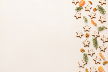 Wall Mural - Composition with delicious stars shaped Christmas cookies, mandarin, walnuts and fir tree branches on light background