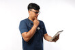 © ArvStd - Portrait of young asian nurse isolated on white background.Holding tablet and thinking gesture