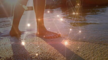Poster - Bare feet walking on beach with glowing network connections animation