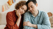 © Postmodern Studio - Caucasian young couple relaxing on couch with peaceful expressions at home