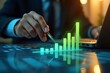 © dex - A Person In A Suit Uses A Pen To Point To A Graph With Bars Showing Growth Next To A Laptop On A Desk. Business Analysis, Financial Growth
