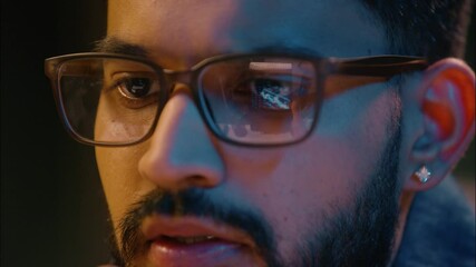 Close up male eyes in glasses Arabian Indian man business guy businessman programmer gamer trader hacker male in eyeglasses reflection graph trading computer screen eye health eyesight vision details