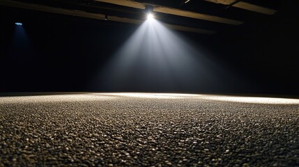 Poster - Spotlight illuminating textured surface in dark room. (1)