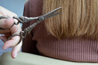 © Виталина Митрофанова - close-up of golden scissors cutting light brown hair precision and care in a hair trimming process minimalist haircare sustainable styling slow beauty natural look natural tools self-care over trends