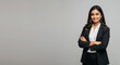 © Vasiliy - Smiling Indian woman in black blazer and white shirt against gray background. Professional portrait for business website, corporate leadership, diversity initiative