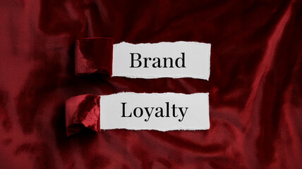 Torn paper pieces on red velvet backdrop display words 