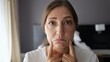 © lenblr - Woman performing facial gymnastics in hotel room
