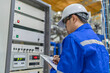 © reewungjunerr - Electrical engineer man checking voltage at the Power Distribution Cabinet in the control room,preventive maintenance Yearly,Thailand Electrician working at company