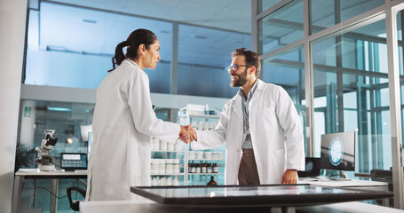 Leinwandbilder - Scientist people, handshake and meeting with screen for review, medical research or innovation. Computer table, interactive display and clinical partnership for science, teamwork study or results