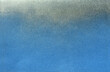 © Curto - silver color spray paint gradient on blue color paper
