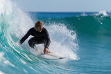 Man is surfing on a wave in the ocean