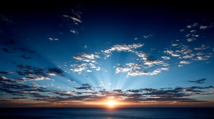 Fototapete - A breathtaking sky filled with deep blues and golds, illuminated by radiant light beams suggesting a divine presence at sunset over a tranquil horizon