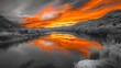 © Auon - Serene river reflecting a fiery orange sunset in selective color with a grayscale mountain range in the background