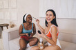 © BullRun - Healthy and beauty lifestyle scene with diverse friends enjoying self-care time and happy interaction during morning routine, cheerful multiracial female in sportswear laughing during makeup time