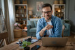 © Miljan Živković - one man adult caucasian work on laptop at home happy smile