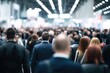© Lindamar - A crowd of indistinct figures fills the exhibition hall during a trade show event. This scene captures the essence of a business convention or job fair, highlighting the dynamic atmosphere of network