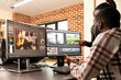 © DC Studio - Professional male editor refining frames as coworker provides visual improvement support. Black man improving film quality at multi monitor workstation with assistance from female creative manager.