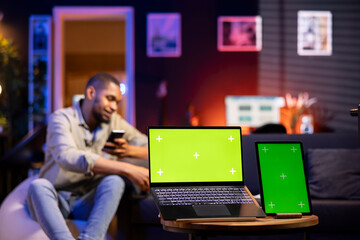 Poster - african american man browses phone next to mockup copy space while he relaxes on a bean bag, feeling
