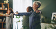 © peopleimages.com - Fitness, stretching and senior people with band in home for exercise, training and workout in living room. Retirement, sports class and women with equipment for wellness, healthy body and cardio