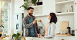 © peopleimages.com - Cheers, health and couple with smoothie in kitchen at home for wellness, diet and nutrition snack. Love, happy and man with woman for toast with green juice for vitamins or hydration in house.