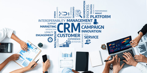 Fototapete - Aerial view of hands working on CRM strategies with documents, charts, and digital tools on a collaborative workspace, emphasizing customer experience and business innovation. Amity