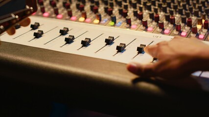 Leinwandbilder - Skilled artist guitarist recording a new song with electro acoustic guitar, composing and editing music in professional studio control room. Young musician songwriter creating tunes. Camera A.
