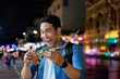 © Mallika - Cheerful Asian man holding Big lobster at local night market