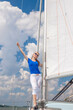 © danmorgan12 - Sea Travel Concepts. One Winsome Happy and Smiling Positive Caucasian Sailor Woman Standing Relaxing on White Yacht At Daytime on Board.