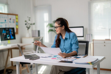 Poster - Young professional woman working with documents and laptop at modern office