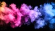 © Phunthip - Colorful smoke swirls against a dark background.