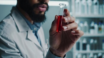 Poster - Medical scientist in pristine white lab coat carefully examining red liquid test tube, conducting precise scientific research in modern laboratory setting