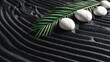 © BONDET LUCKY - Arranging White Stones with Green Palm Leaf on Black Sand Texture